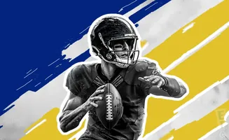 A black and white image of a football quarterback in uniform holding a football, with blue and yellow streaks in the background.