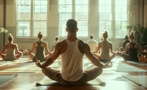 A group of people meditate in a sunlit room.