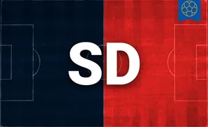 a san diego fc soccer player kicking the ball midair