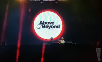 Above & Beyond logo on a large screen with two DJs below.