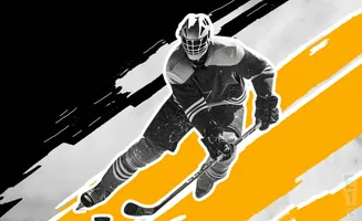 A hockey player in a mask and uniform skates with a stick.
