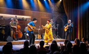 A band performs on stage for an audience.
