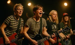 A band plays on stage, with the lead singer in the center belting into a microphone.