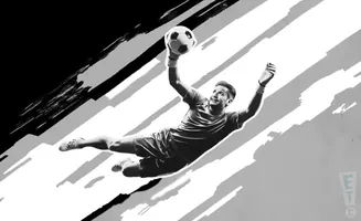 A black and white image of a soccer goalie diving to catch a ball.