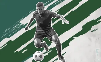 Soccer player in black uniform dribbling a ball, with green and white abstract brush strokes in the background.
