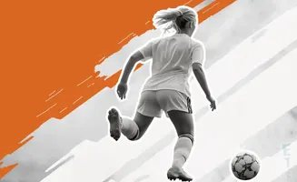 A female soccer player in a white jersey and shorts kicks a soccer ball.