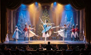 Ballet dancers perform on a stage with a Christmas tree backdrop, accompanied by an orchestra.