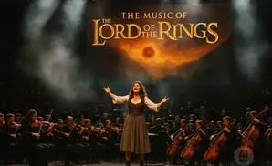 A woman sings on stage with an orchestra under a 