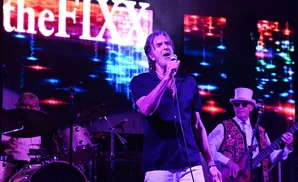 Singer in black shirt on stage with 