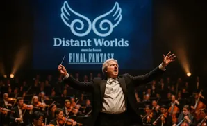 A conductor leads an orchestra on stage with a 