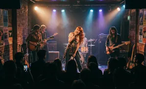 A band performs on a stage in a dimly lit venue, with a singer in the foreground.