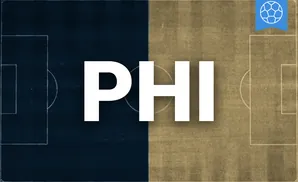 a philadelphia union soccer player kicking the ball down field