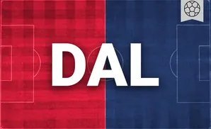 a fc dallas soccer player kicking the ball down field