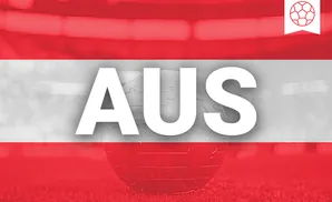 Glass globe with a soccer ball emblem on a background of the Austrian flag.