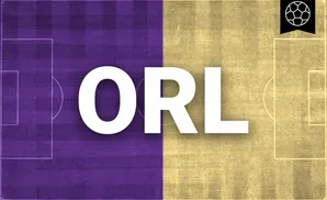 Soccer field split in half, purple on the left and yellow on the right, with a soccer ball emblem in the top right.