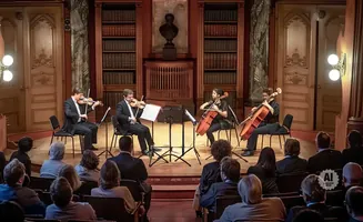 String quartet performs in a grand library with audience watching.