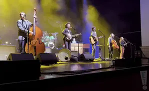 the avett brothers performing on stage shot of entire band