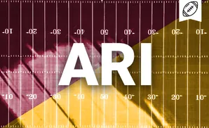 Football field marked with yard lines in maroon and gold, split diagonally.