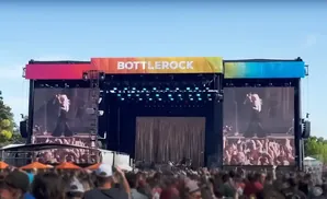 Bottlerock festival stage with screens showing a blonde performer and a crowd.