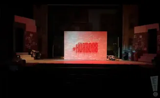 A stage with a brick wall that says 