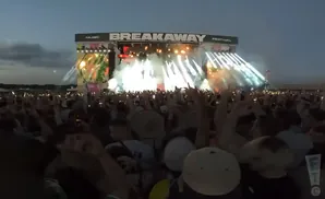 Crowd at Breakaway Festival with a stage, lights, and smoke.