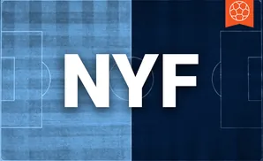 An aerial view of a soccer field split in half, light blue on the left, dark blue on the right, with a soccer ball icon in the top right corner.