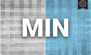 a minnesota united fc soccer player kicking the ball down field 