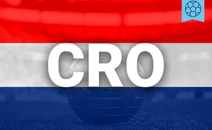 A glass globe rests on grass, superimposed on a flag with red, white, and blue stripes.