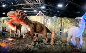 Animatronic dinosaurs in a museum exhibit.