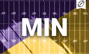 A football field with purple on the left and gold on the right, divided diagonally.