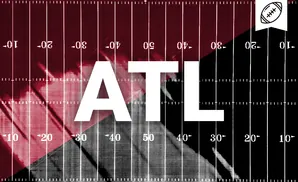 A football field graphic with a diagonal divide, maroon on the left, black on the right, with yard lines and numbers.