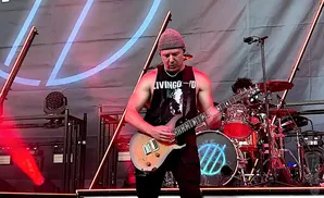 i prevail electric guitarist playing live on stage