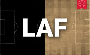 A soccer field split down the middle, half black and half sepia-toned, with a red soccer ball emblem in the top right.