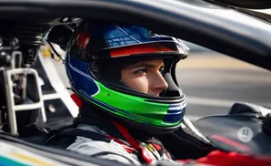 A race car driver in a blue and green helmet peers forward, ready to race.