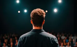 a rear view photo of comedian drew lynch performing a comedy act on stage