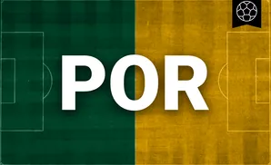 a portland timbers soccer player kicking the ball down field 