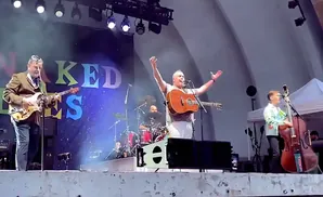 A band performs on stage with a 