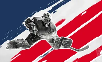 A hockey goalie in full gear dives to make a save with a hockey stick.