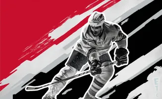 A black and white hockey player in action against a red and black background.
