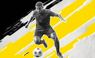 A Black soccer player in a black jersey and shorts dribbles a soccer ball against a bold yellow and black abstract background.