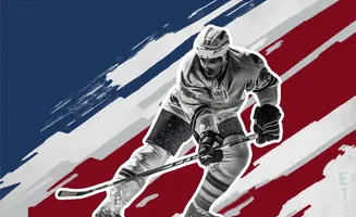 A hockey player in uniform skates with his stick, against a backdrop of red, white, and blue stripes.