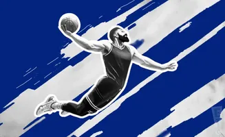 A basketball player dunks the ball against a blue and white striped background.