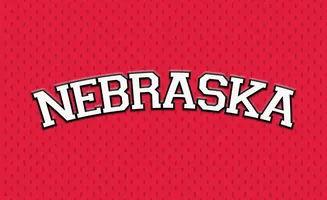 Nebraska text in white with a black outline arches over a red, diamond-patterned background.