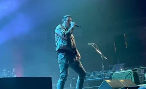 breaking benjamin performing on stage under green and blue lights