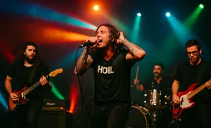 A band performs on stage with colorful lights. The lead singer is in the foreground.