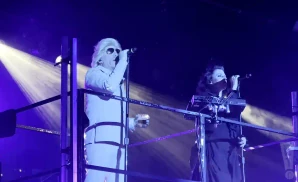 puscifer singers singing on a tall stage