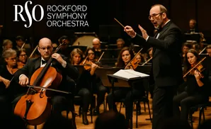A conductor leads a symphony orchestra with a cellist in the foreground.