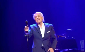 salvatore adamo singing live on stage in a suit in liège belgium