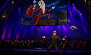 A conductor leads an orchestra performing 