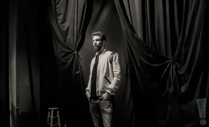 a rear view photo of comedian anthony jeselnik performing a comedy act on stage